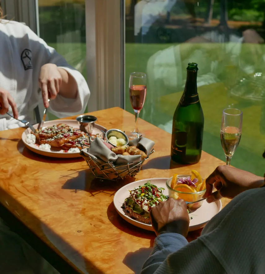 Table with seafood, champagne, and shared dishes