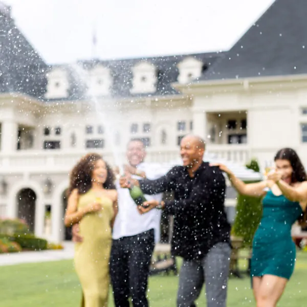 Friends celebrating with champagne outdoors