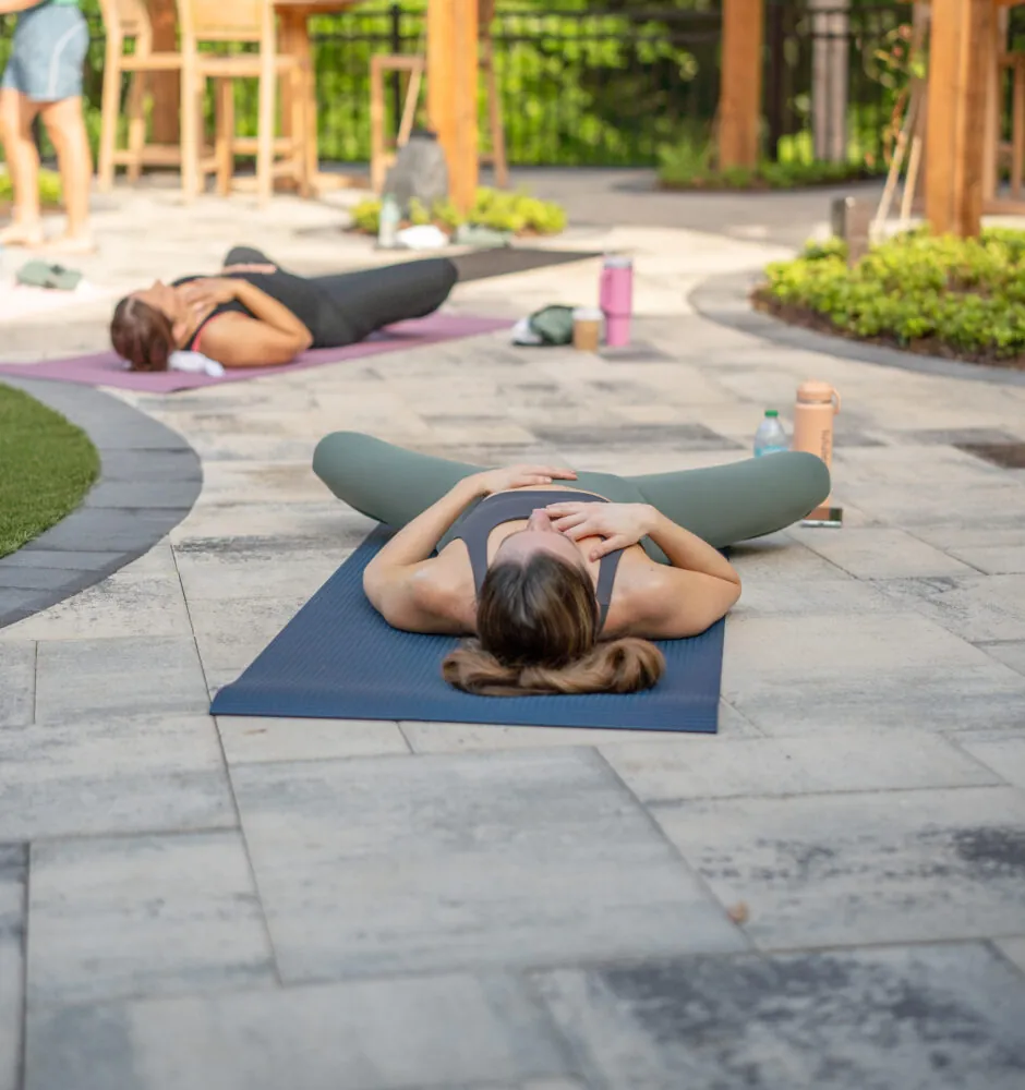 Women practicing yoga on outdoor mats