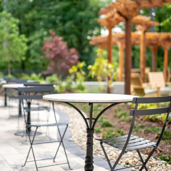 An outdoor table and chairs in a garden setting.
